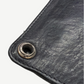 Chrome Hearts black leather wallet corner detail showing silver grommet eyelet and topstitched leather grain