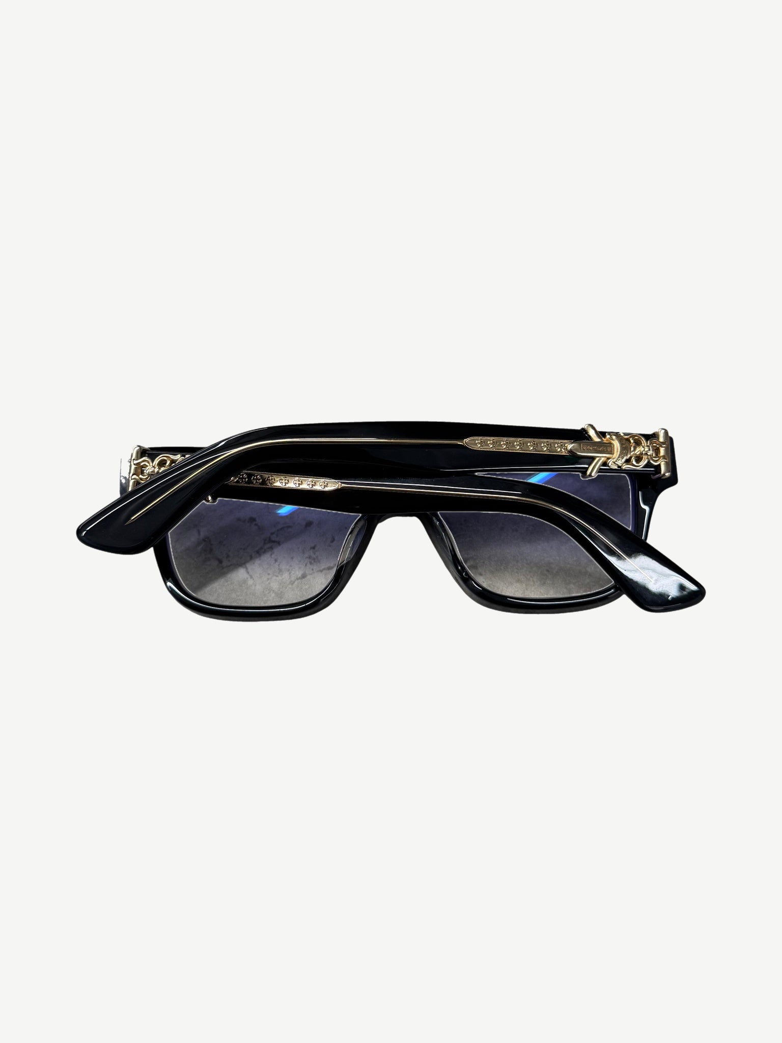 Chrome Hearts Vagillionaire black acetate glasses temple detail with engraved gold CH branding.