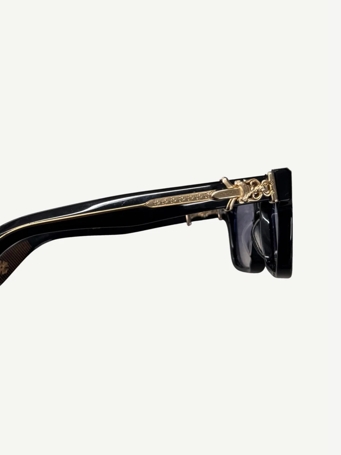 Chrome Hearts Vagillionaire glasses angled view showing gold CH cross temple hardware accent.