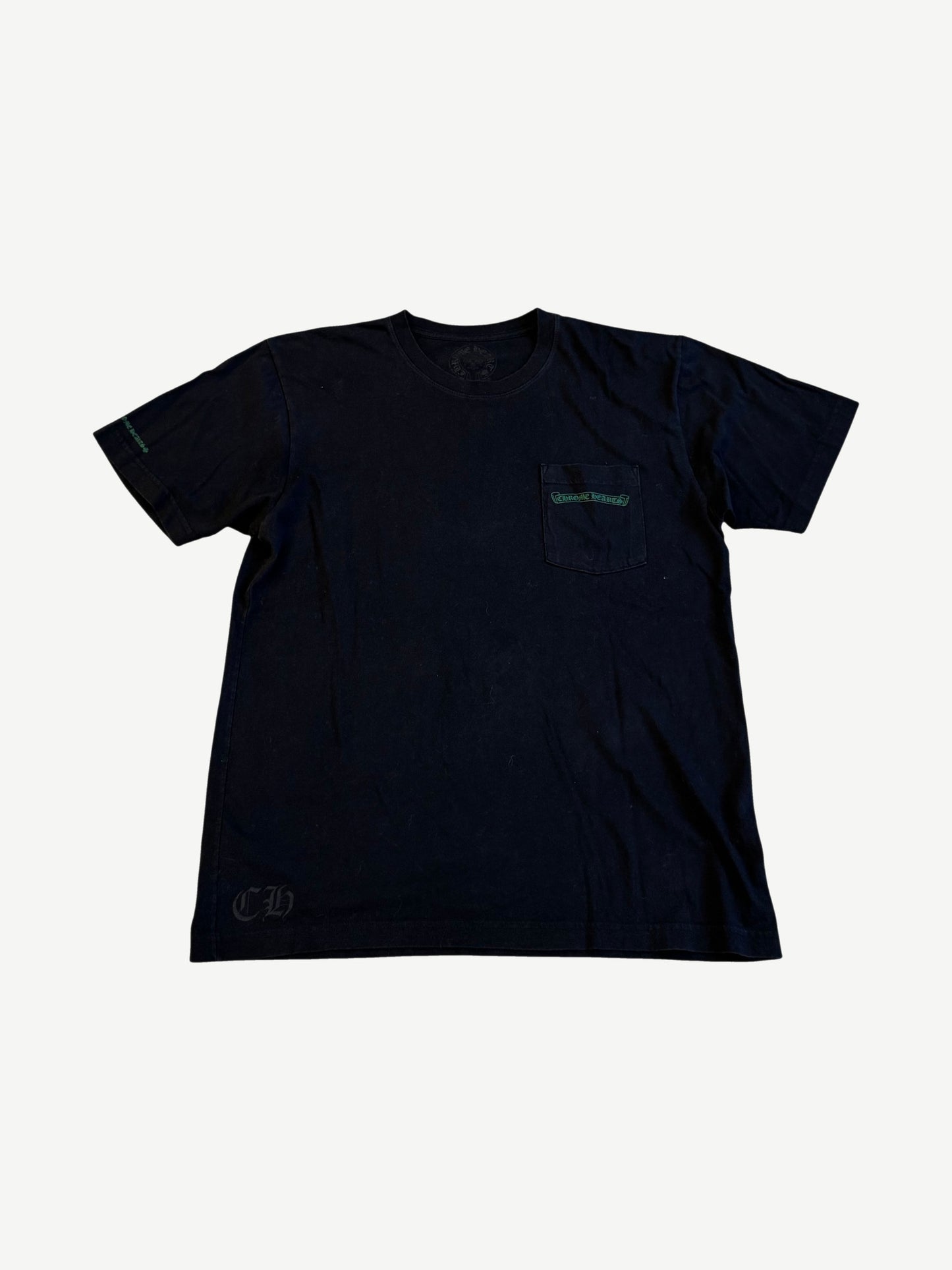 Chrome Hearts black pocket tee with green Cemetery Cross logo print on chest pocket and sleeve.