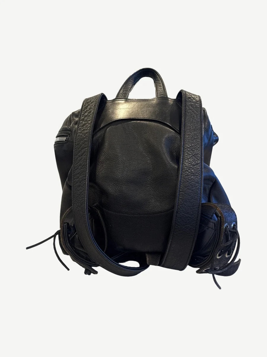 Chrome Hearts black Gunslinger leather backpack detail view showing cross patch hardware and stitching