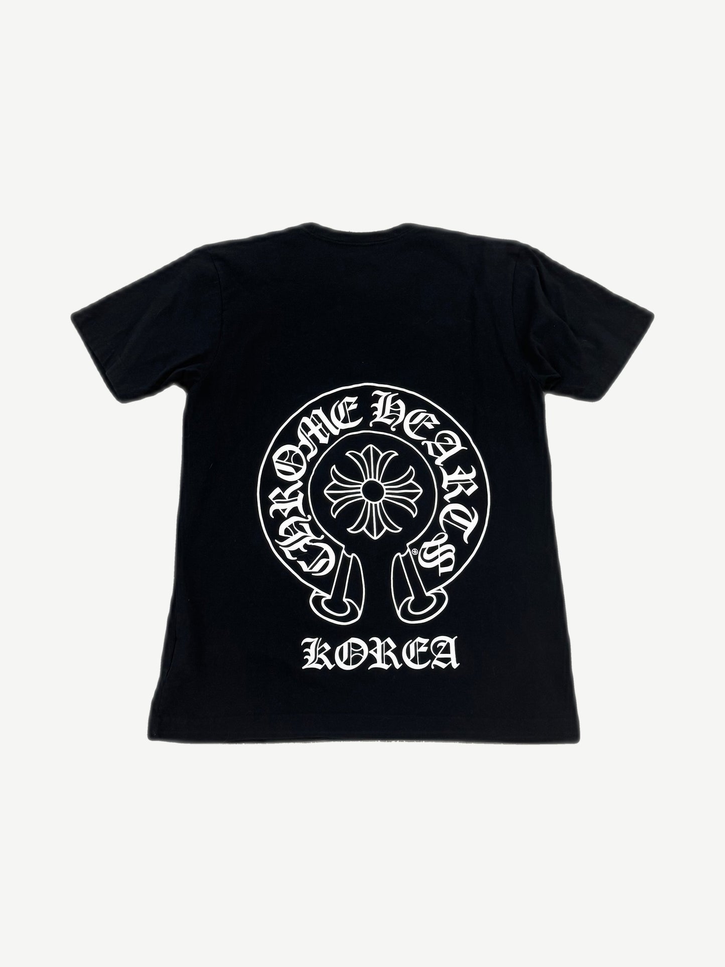 Back of Chrome Hearts black tee with large white horseshoe cross logo and Korea gothic text