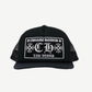 Chrome Hearts Las Vegas CH trucker hat in black with white embroidered gothic CH cross logo patch on front.