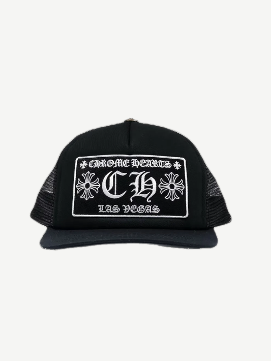 Chrome Hearts Las Vegas CH trucker hat in black with white embroidered gothic CH cross logo patch on front.