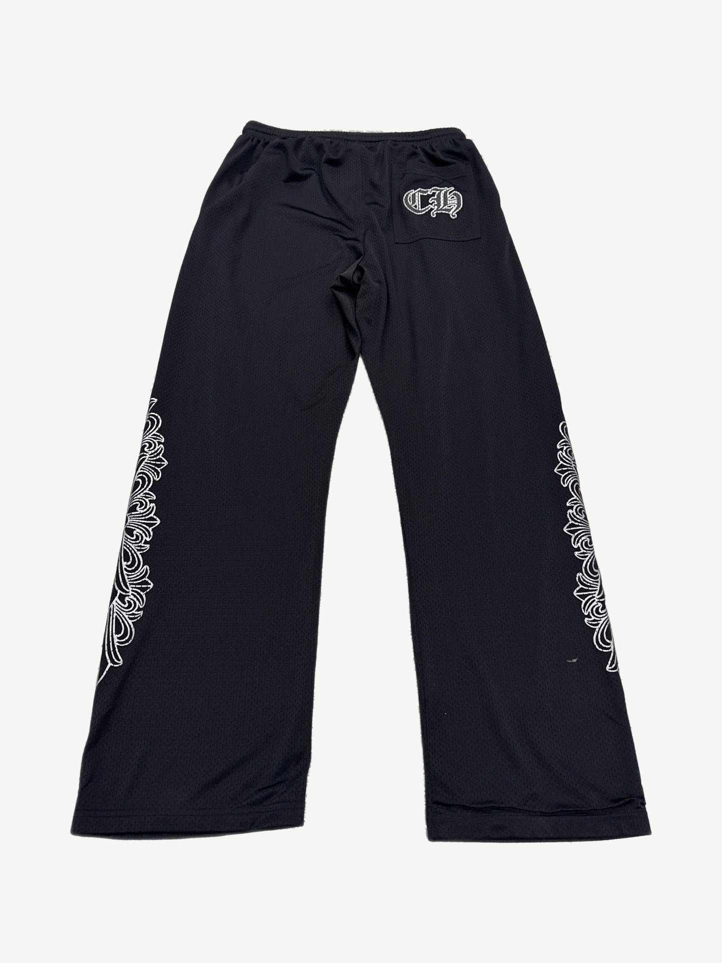 Back view of Chrome Hearts black mesh warm up sweatpants with CH gothic pocket logo and dagger leg embroidery