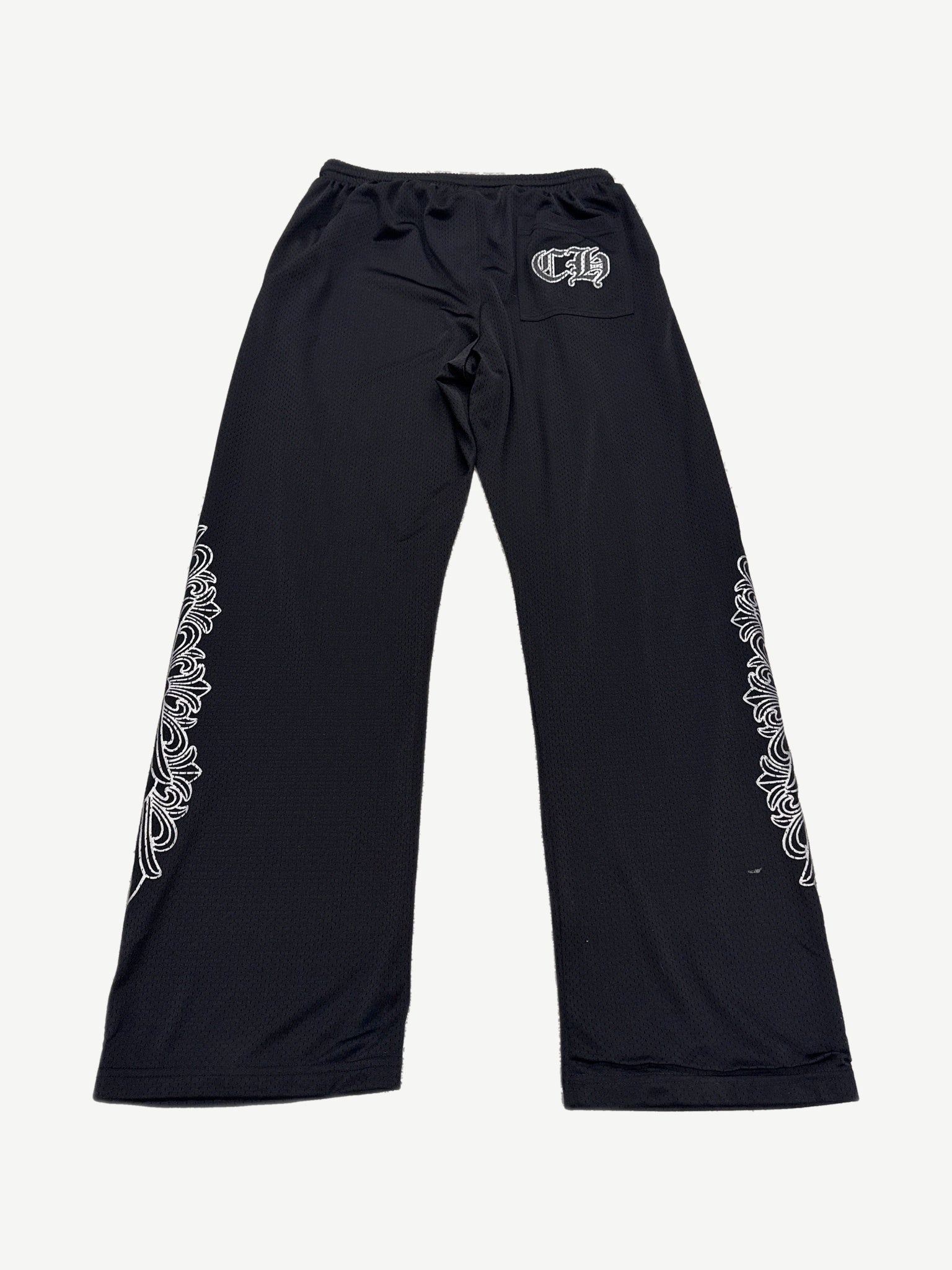 Back view of Chrome Hearts black mesh warm up sweatpants with CH gothic pocket logo and dagger leg embroidery