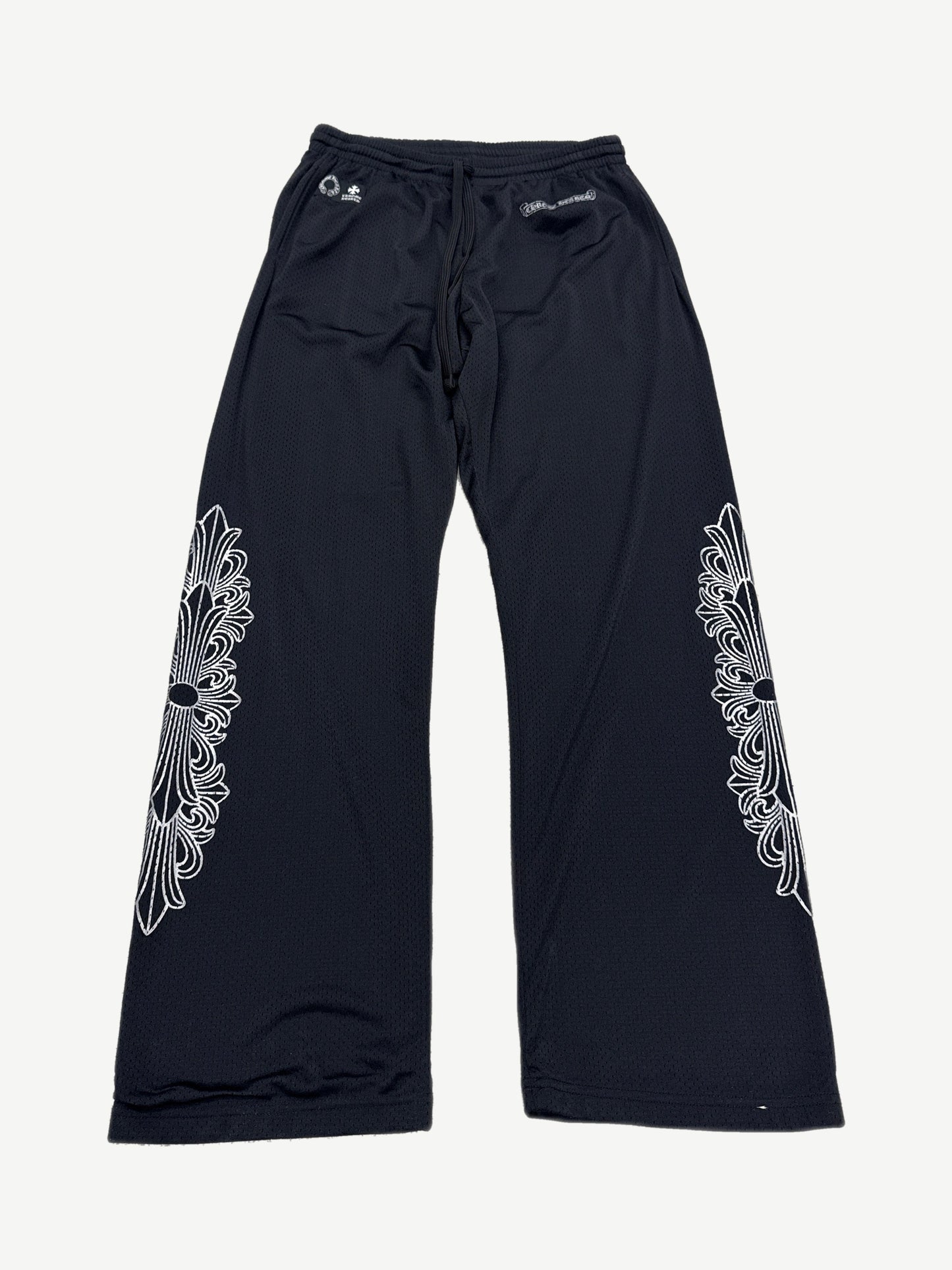 Chrome Hearts black mesh warm up sweatpants with white floral cross dagger embroidery on both legs, front view
