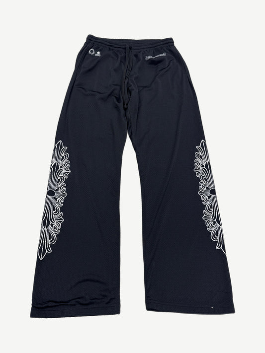 Chrome Hearts black mesh warm up sweatpants with white floral cross dagger embroidery on both legs, front view