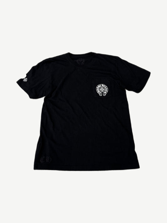 Chrome Hearts black tee front with white horseshoe pocket print and CH old English hem text.