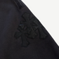 Chrome Hearts Paper Jam sweatpants close-up of stacked black leather cross patch cluster on thigh