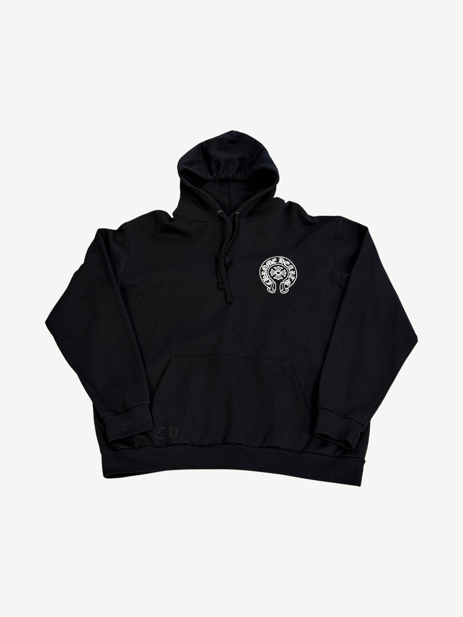 Chrome Hearts Paris horseshoe hoodie front in black with embroidered white horseshoe logo on left chest