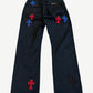 Chrome Hearts black cross patch chinos back view showing red and blue leather cross patches across the seat.