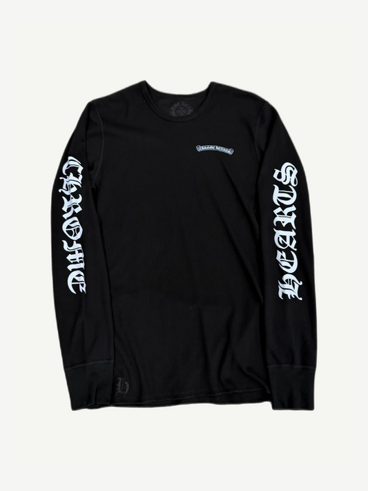 Chrome Hearts black waffle-knit thermal longsleeve with gothic scroll logo chest print and ribbed cuffs.