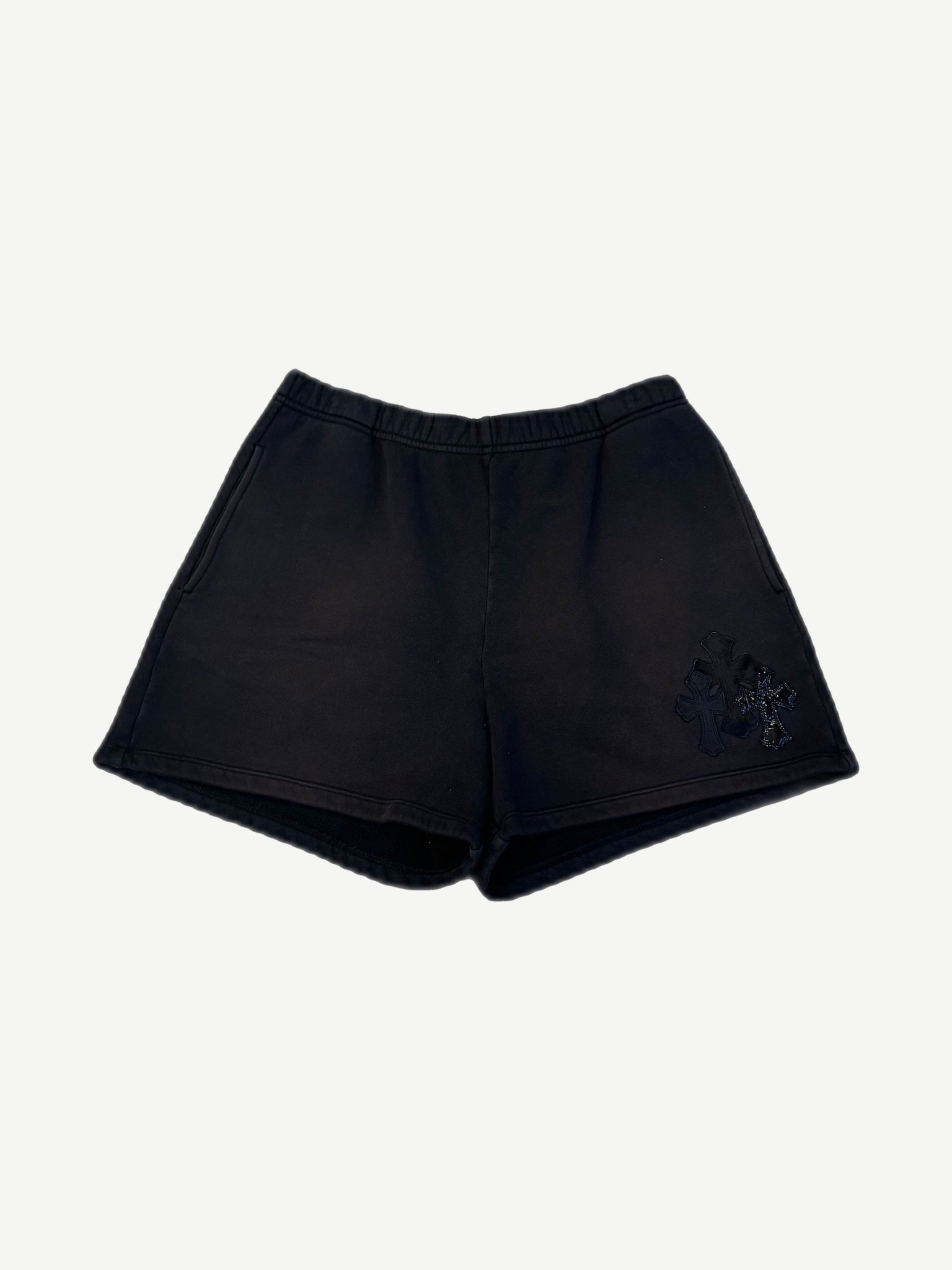 Chrome Hearts black sweat shorts with triple cross leather patches stacked on right leg, elastic waist front