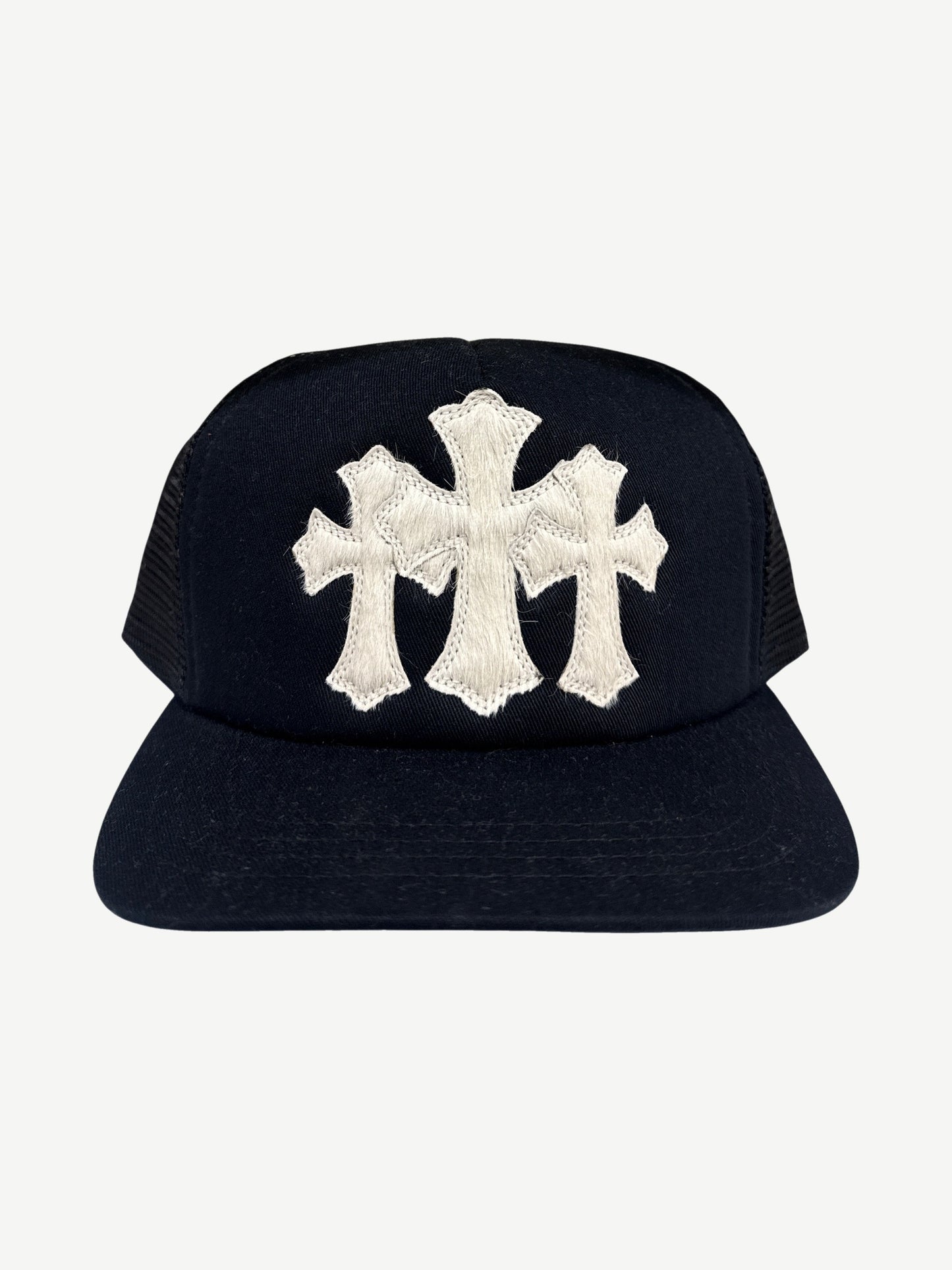 Chrome Hearts black trucker hat front with white pony hair triple cross patch and snapback closure detail.