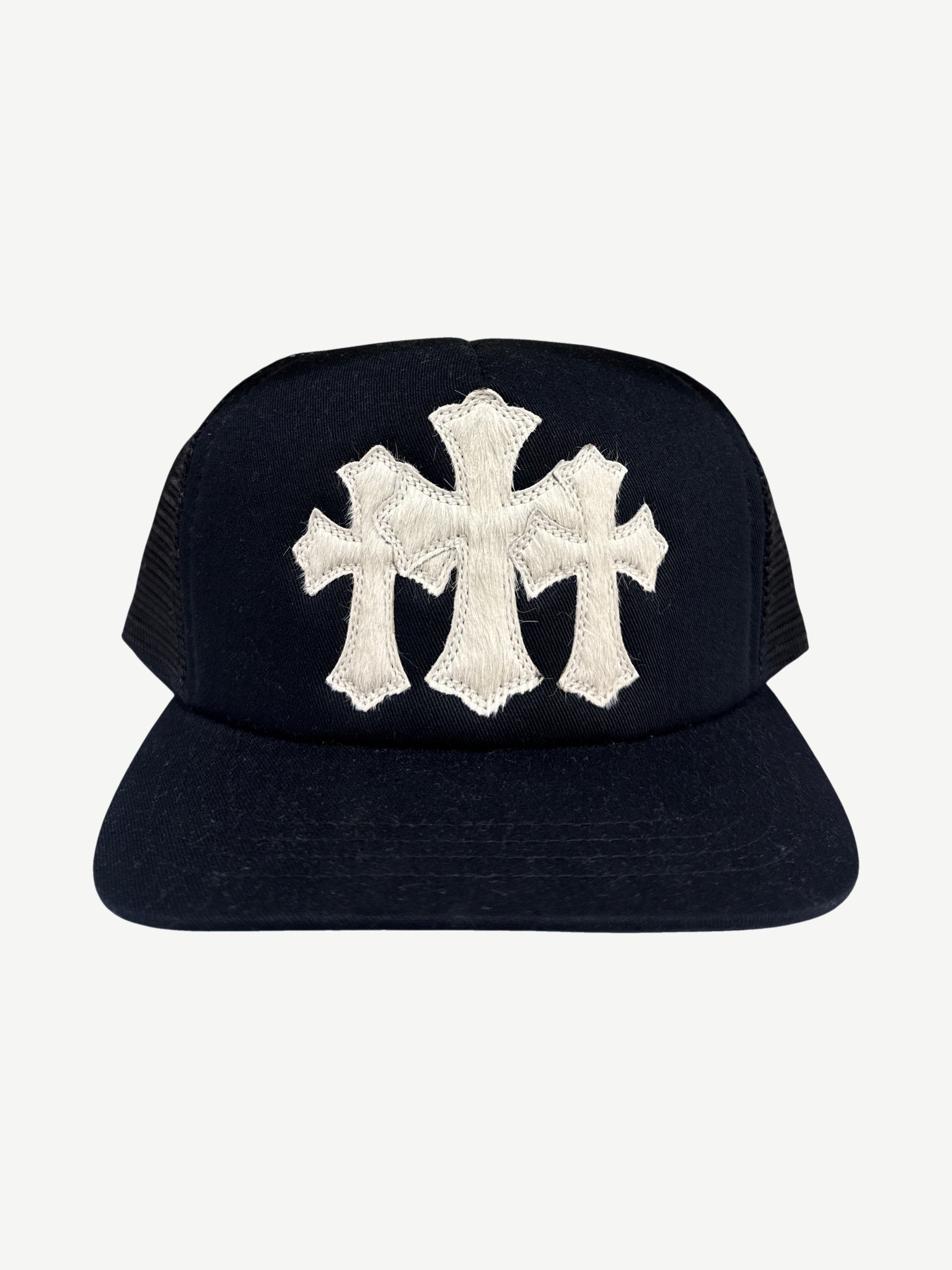 Chrome Hearts black trucker hat front with white pony hair triple cross patch and snapback closure detail.