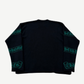 Chrome Hearts black cashmere sweater detail showing green knit Chrome Hearts gothic scroll on sleeve