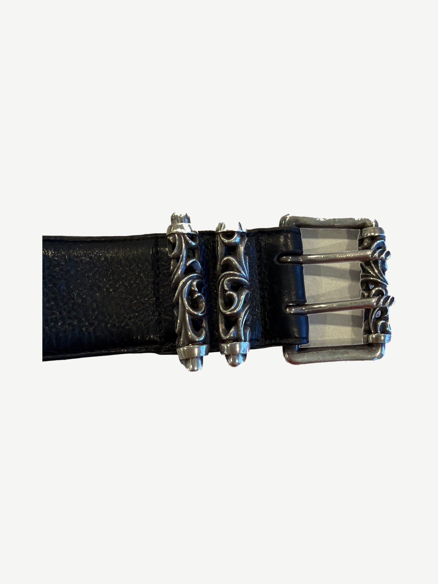 Chrome Hearts Celtic double pin roller belt buckle close-up with sterling silver scroll fleur and twin prongs