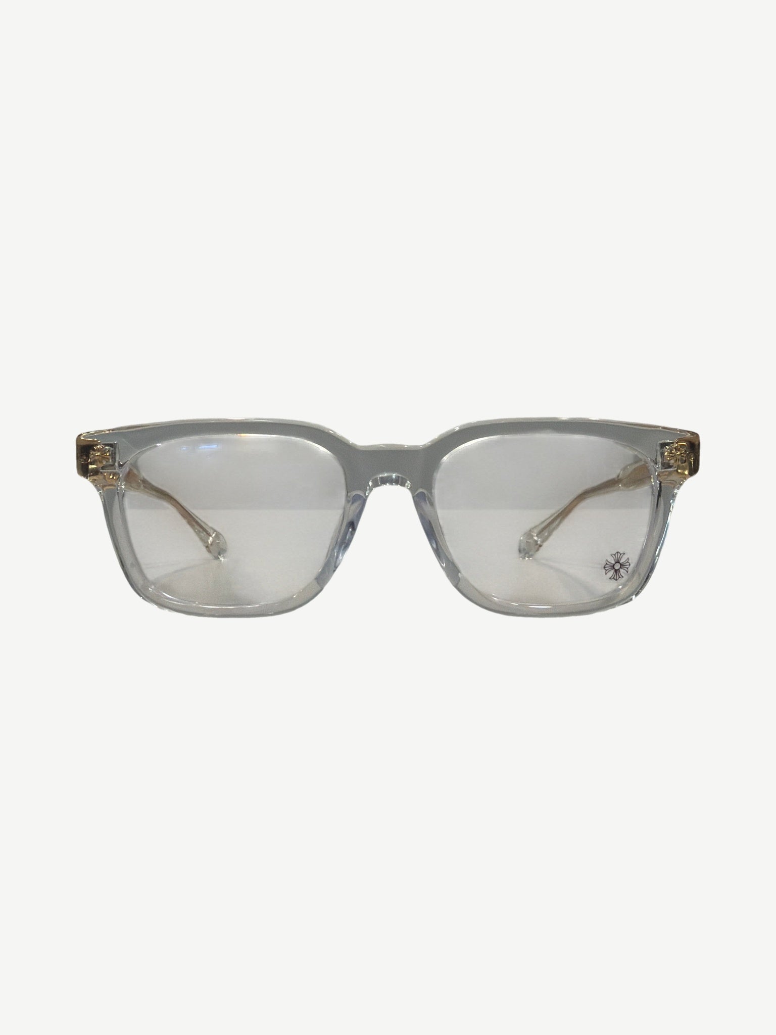 Chrome Hearts Cox Ucker eyeglasses, clear acetate frames with gold metal temple accents and dagger logo.