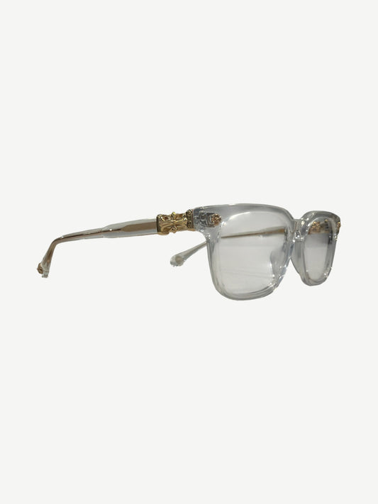Chrome Hearts Cox Ucker clear frames side profile, transparent acetate with engraved gold Chrome Hearts temple.