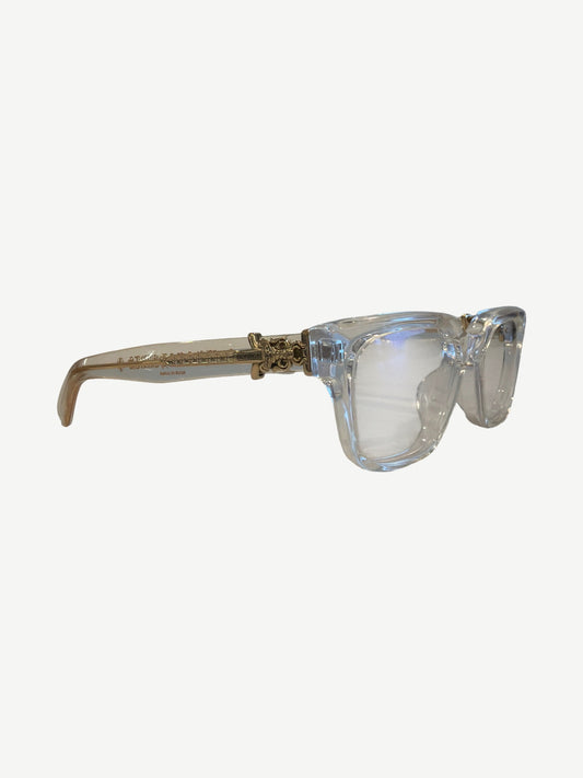 Chrome Hearts Vagillionaire clear glasses side profile showing gold engraved temple hardware