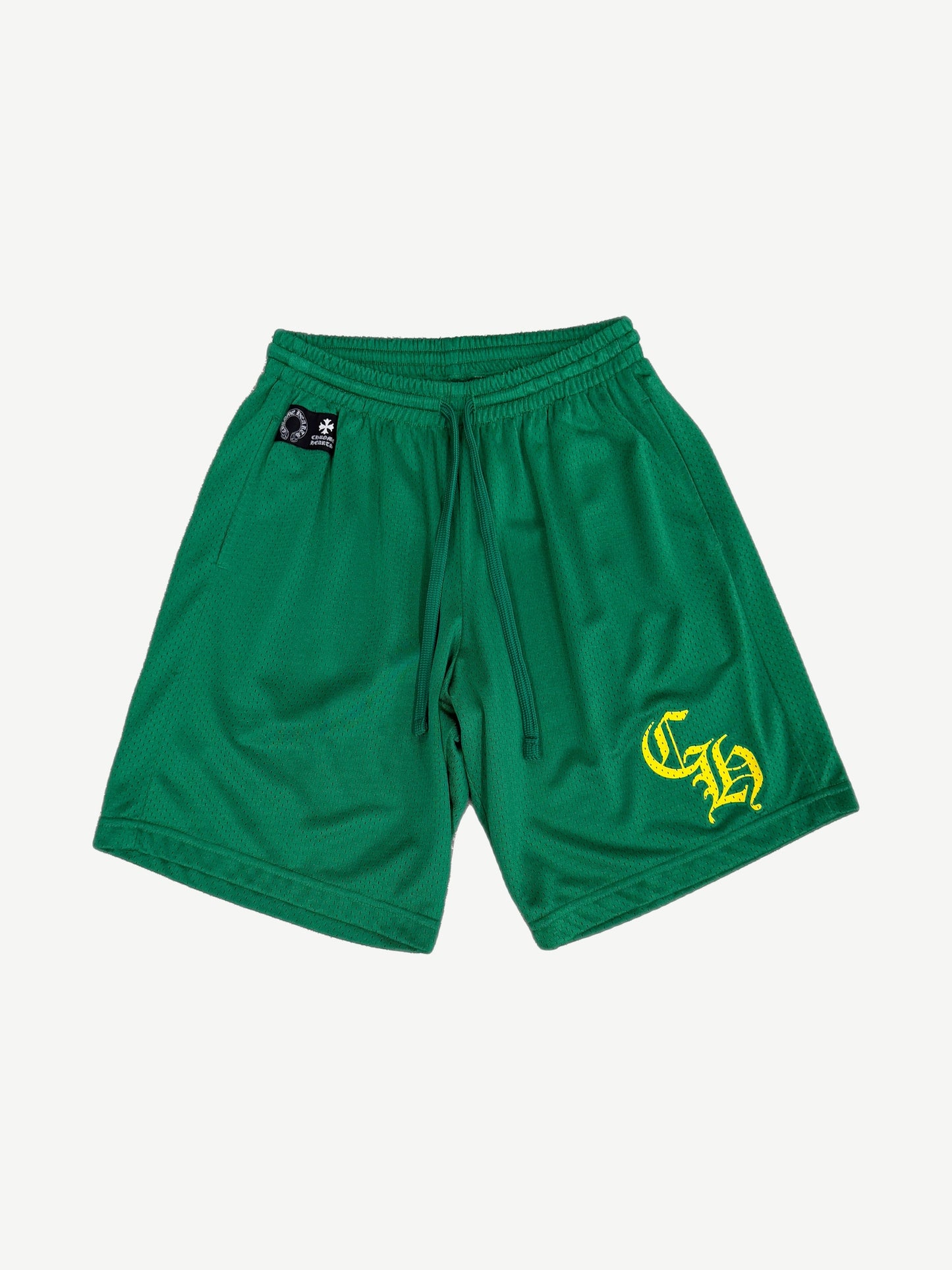 Chrome Hearts green mesh shorts front with yellow CH gothic logo on leg and woven brand tag