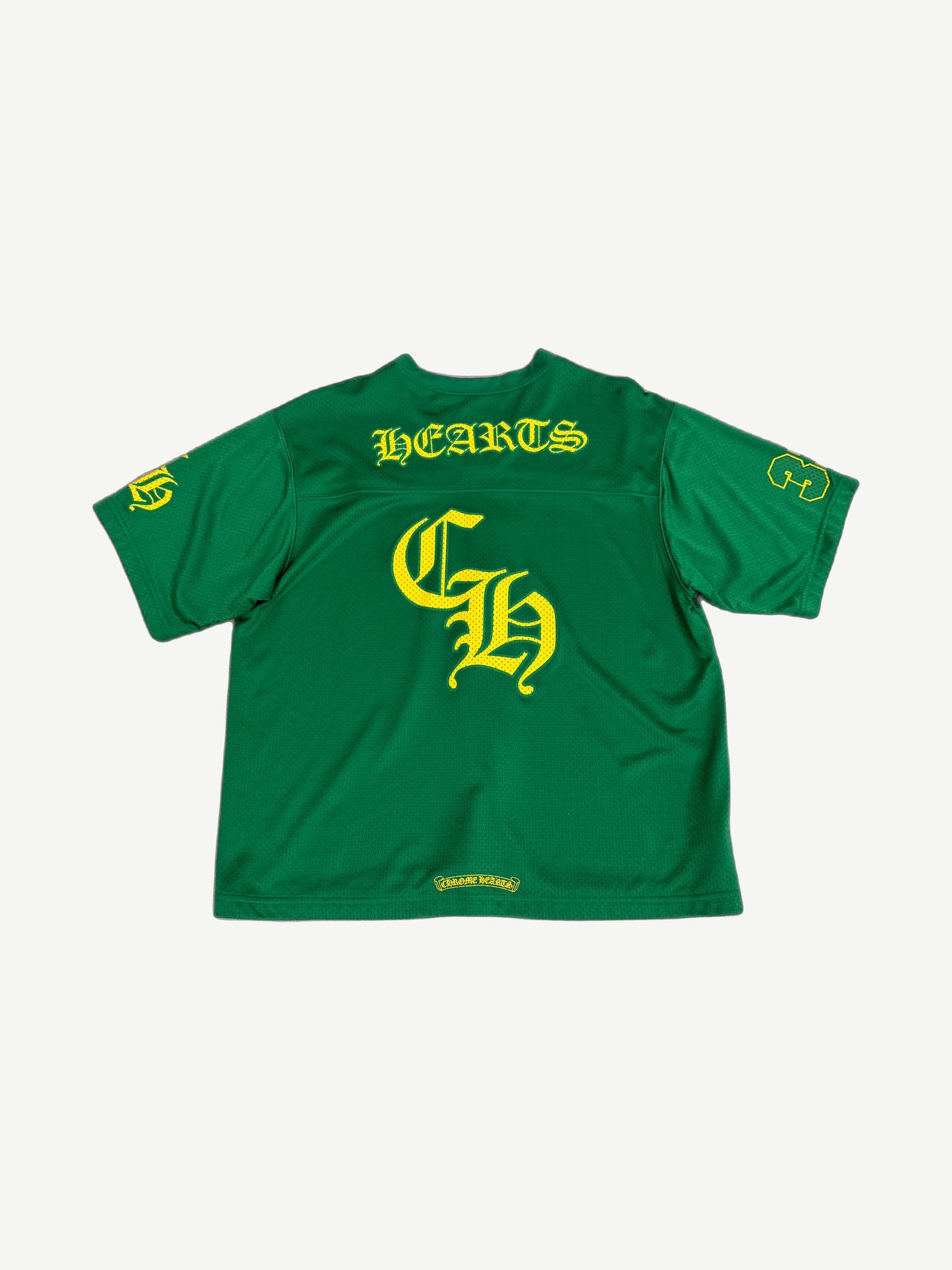 Chrome Hearts green mesh jersey back, large yellow HEARTS arch over Old English CH and numbered yellow sleeves.