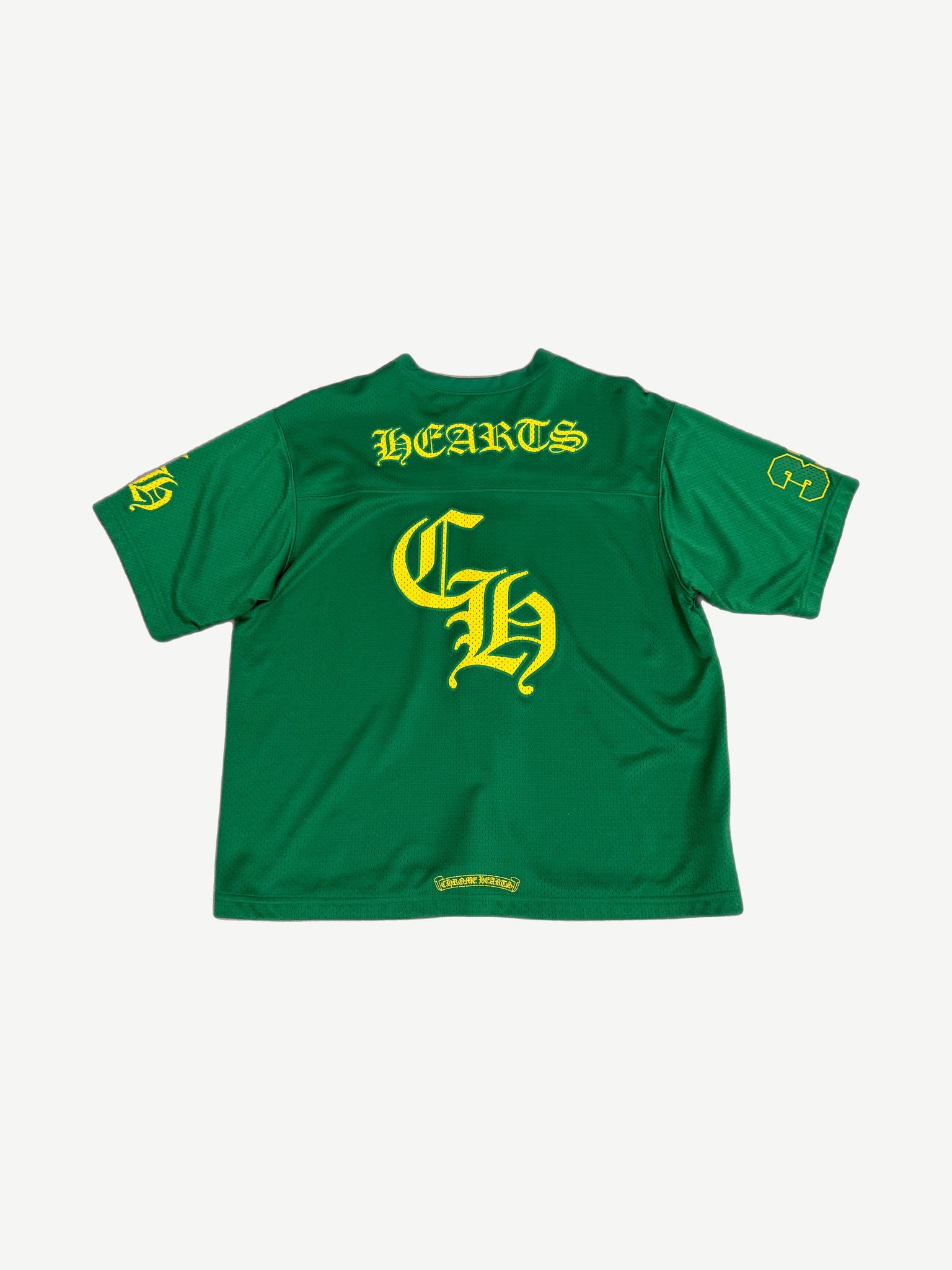 Chrome Hearts green mesh jersey back, large yellow HEARTS arch over Old English CH and numbered yellow sleeves.