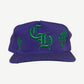 Chrome Hearts purple baseball hat with green Old English CH embroidery and cross patches on side panels, front view