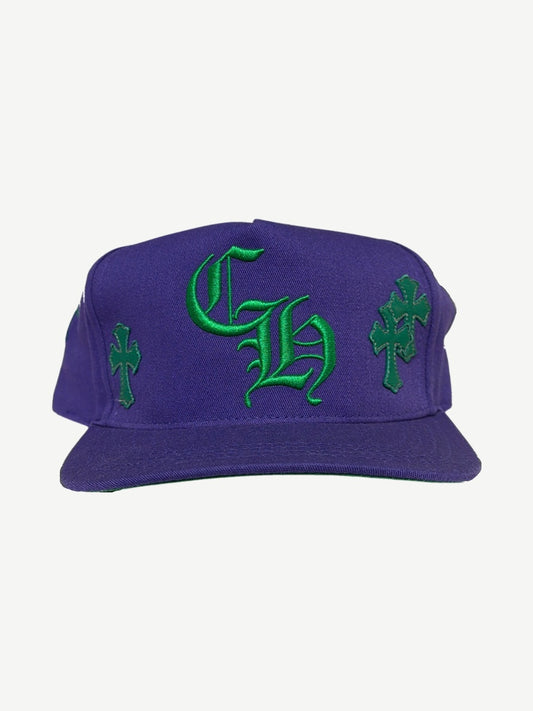 Chrome Hearts purple baseball hat with green Old English CH embroidery and cross patches on side panels, front view