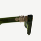Chrome Hearts Sitonit sunglasses close up of silver fleur cross temple hardware on translucent green frame