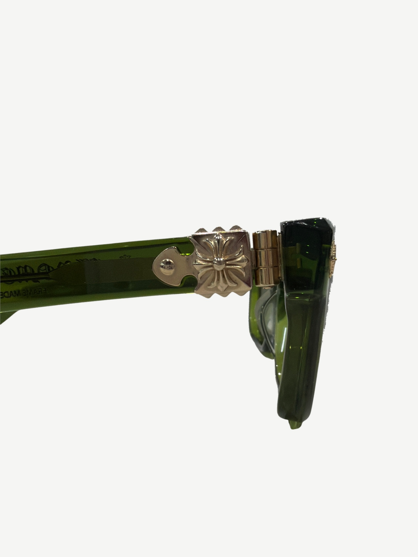 Chrome Hearts Sitonit sunglasses close up of silver fleur cross temple hardware on translucent green frame