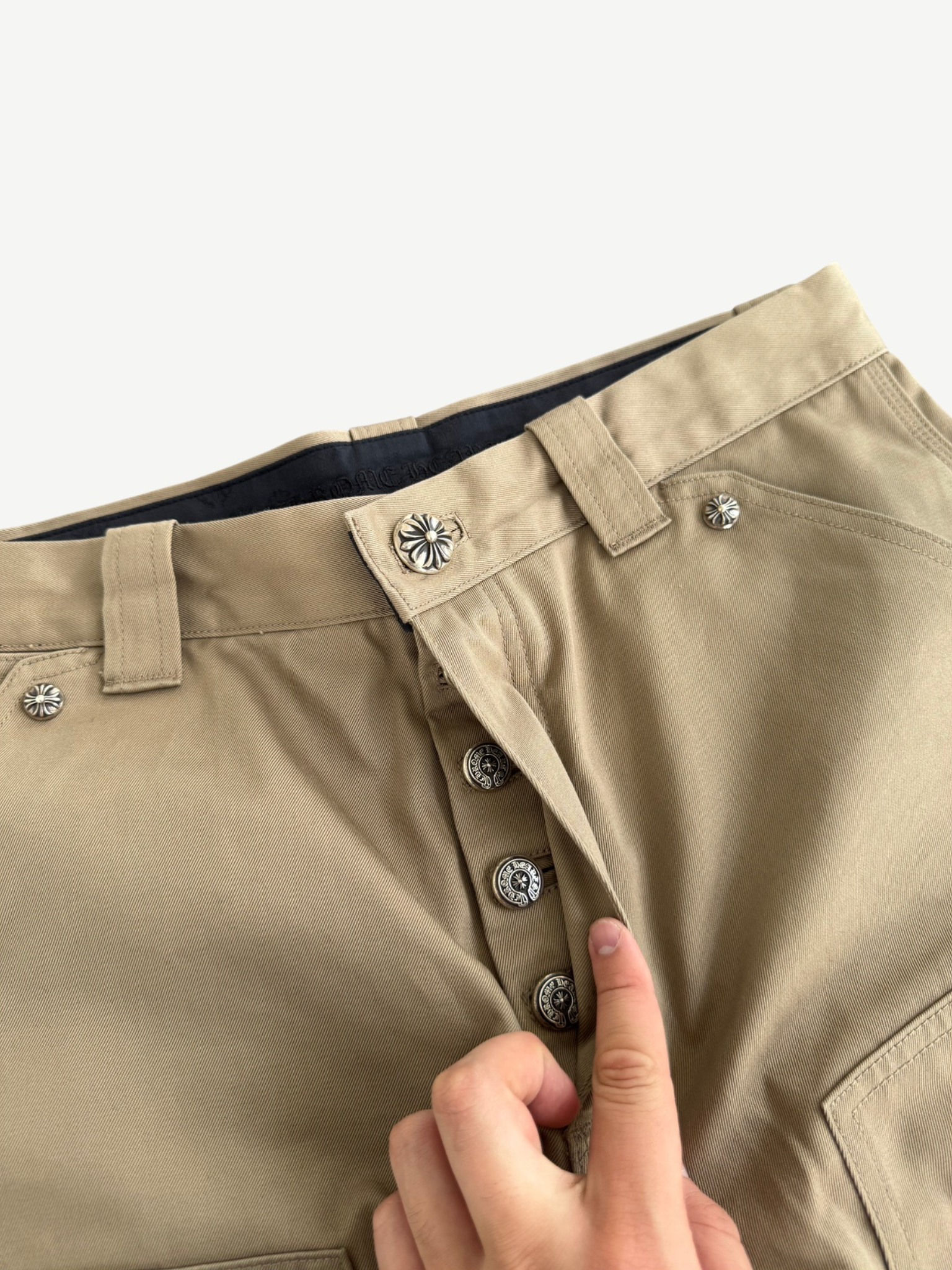 Chrome Hearts khaki carpenter pants laid flat showing tan canvas fabric and double-knee utility paneling