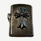 Chrome Hearts sterling silver Zippo lighter with raised CH cross emblem centered on tarnished case, front view
