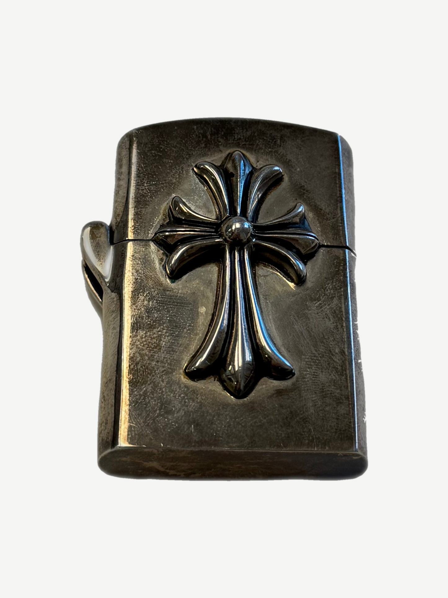 Chrome Hearts sterling silver Zippo lighter with raised CH cross emblem centered on tarnished case, front view