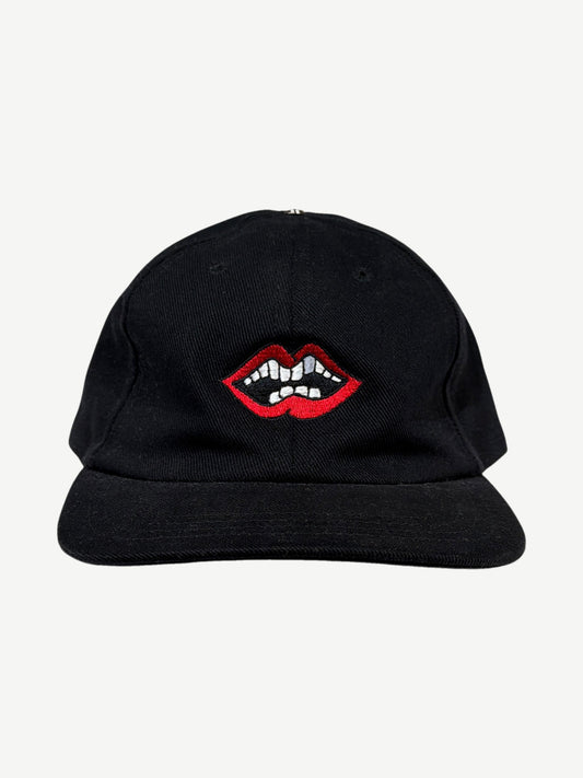 Chrome Hearts x Matty Boy black Chomper strapback cap with embroidered red lips and teeth graphic at front