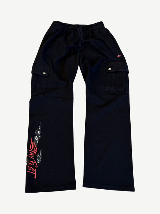 Chrome Hearts Matty Boy black cargo sweatpants front with flame and red Stay Fast script print on left leg cuff.
