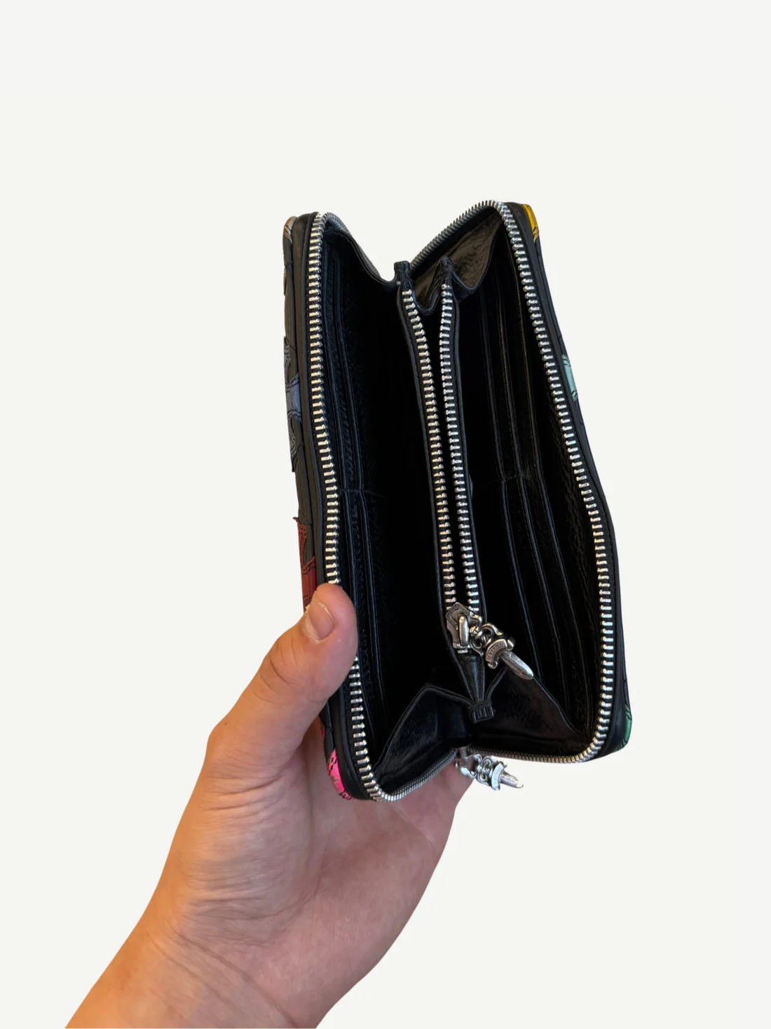 Chrome Hearts wallet inner zip pockets shown open with dual currency compartments and silver hardware.