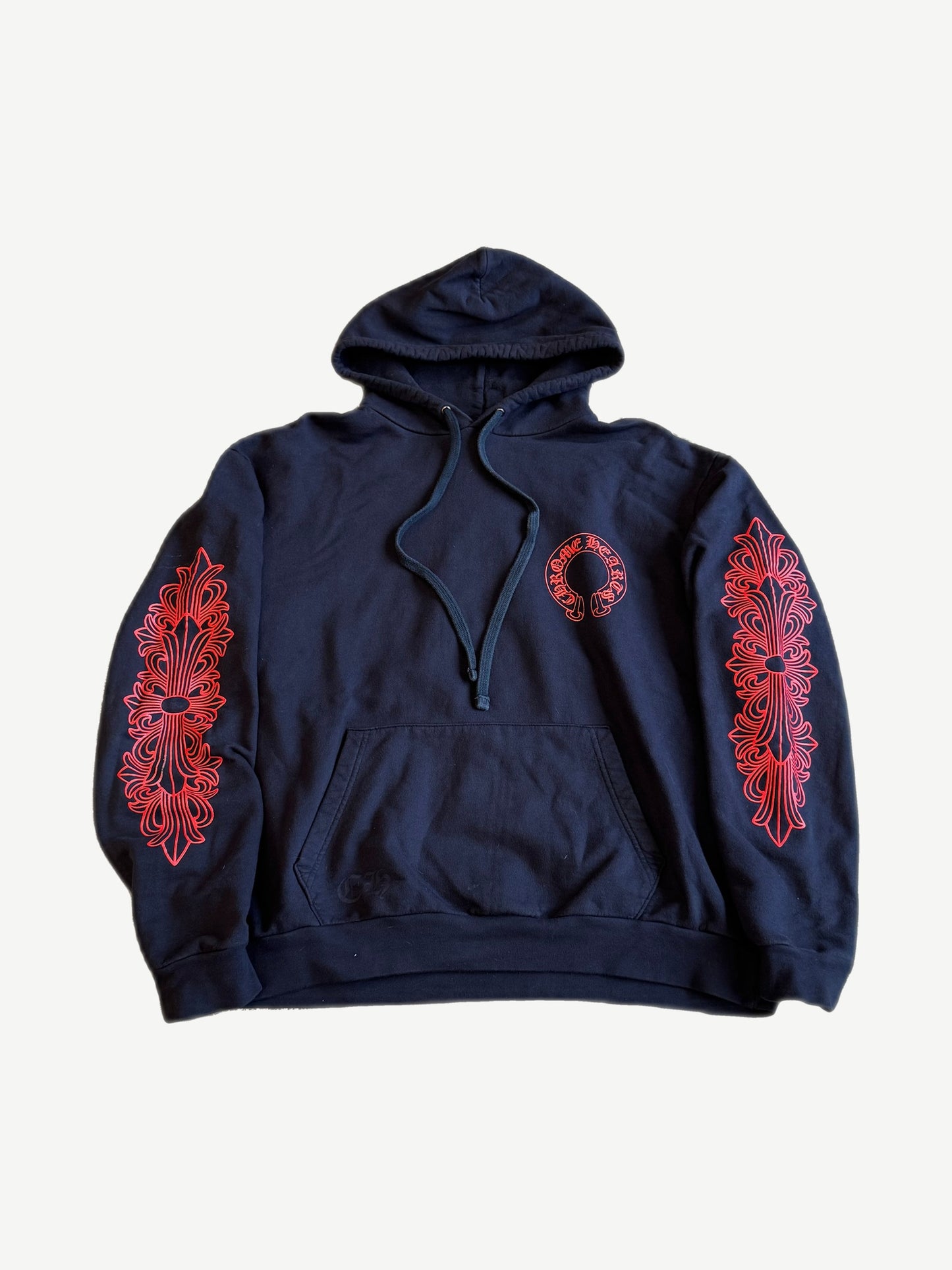 Chrome Hearts navy hoodie front with red horseshoe chest logo and red floral cross prints down both sleeves