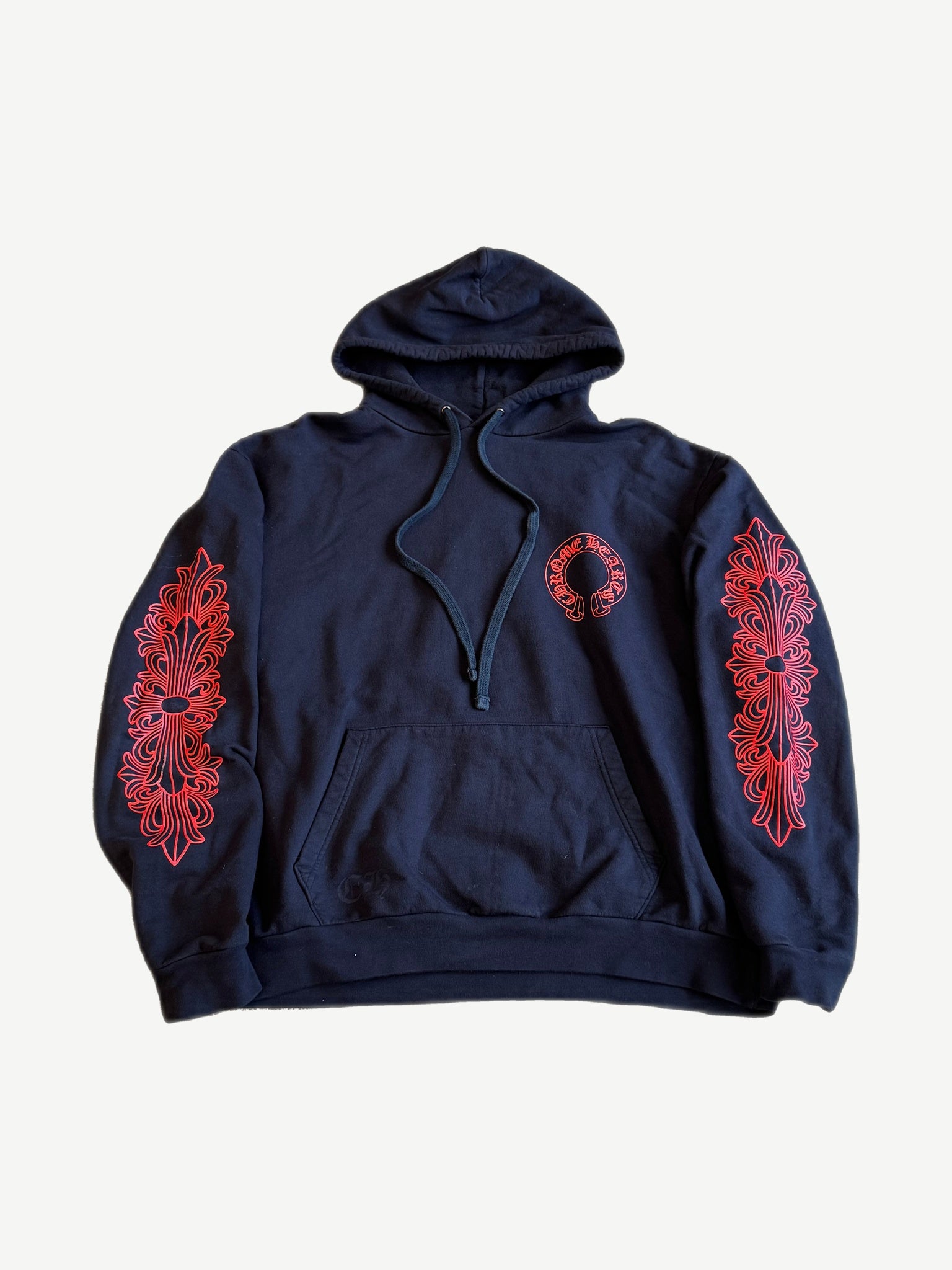 Chrome Hearts navy hoodie front with red horseshoe chest logo and red floral cross prints down both sleeves
