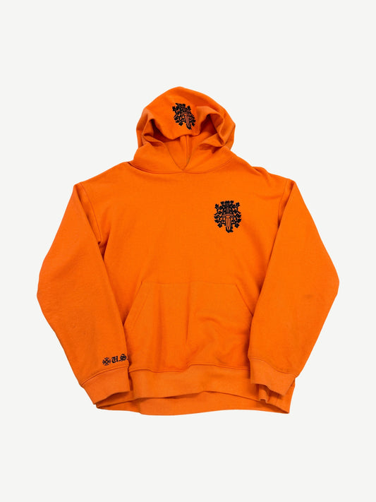 Chrome Hearts orange hoodie front with small black vine dagger chest graphic and U.S.A. embroidered cuff