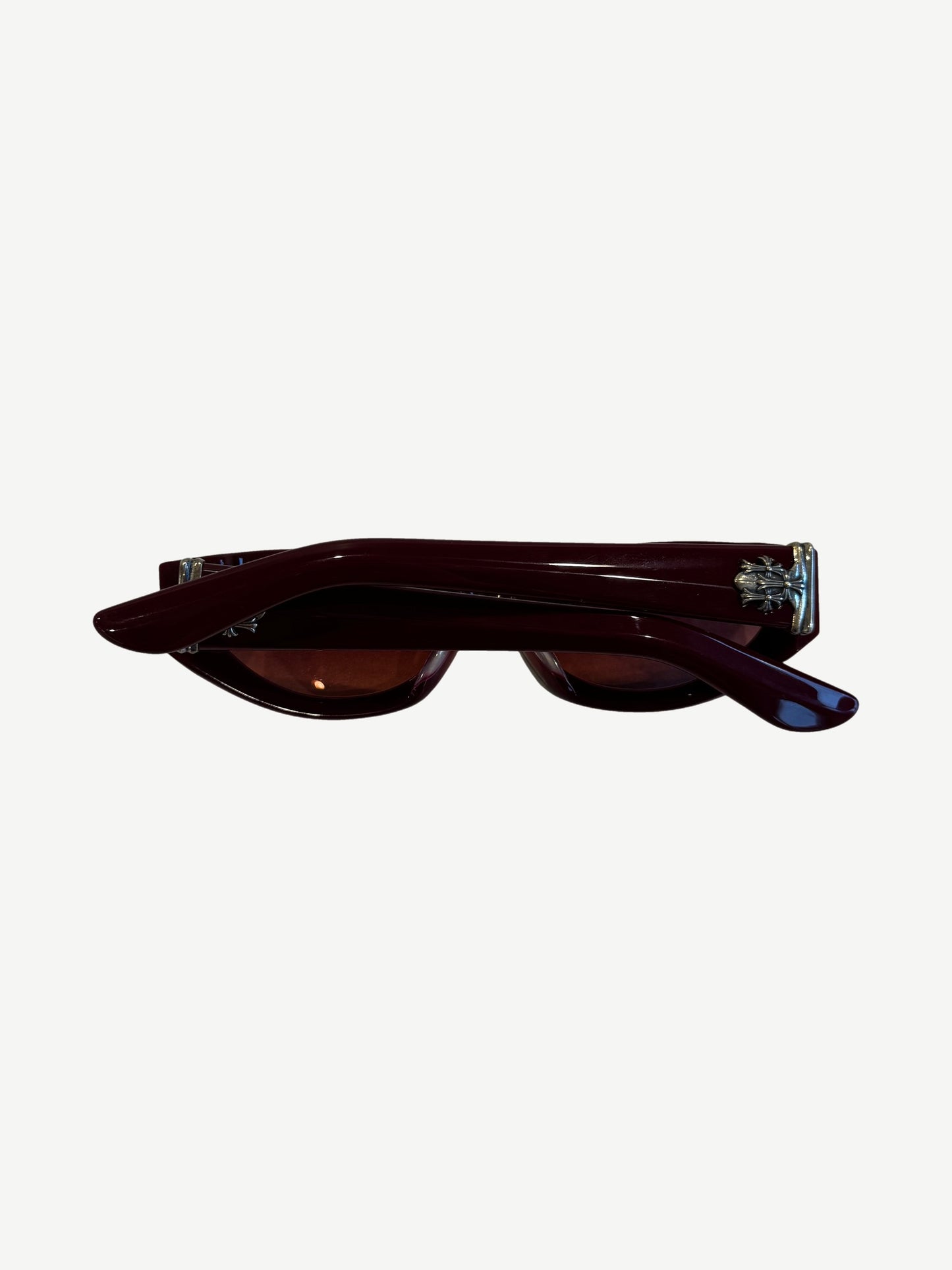 Chrome Hearts red Edenbox sunglasses side profile showing silver cross hardware at temples and burgundy arms.
