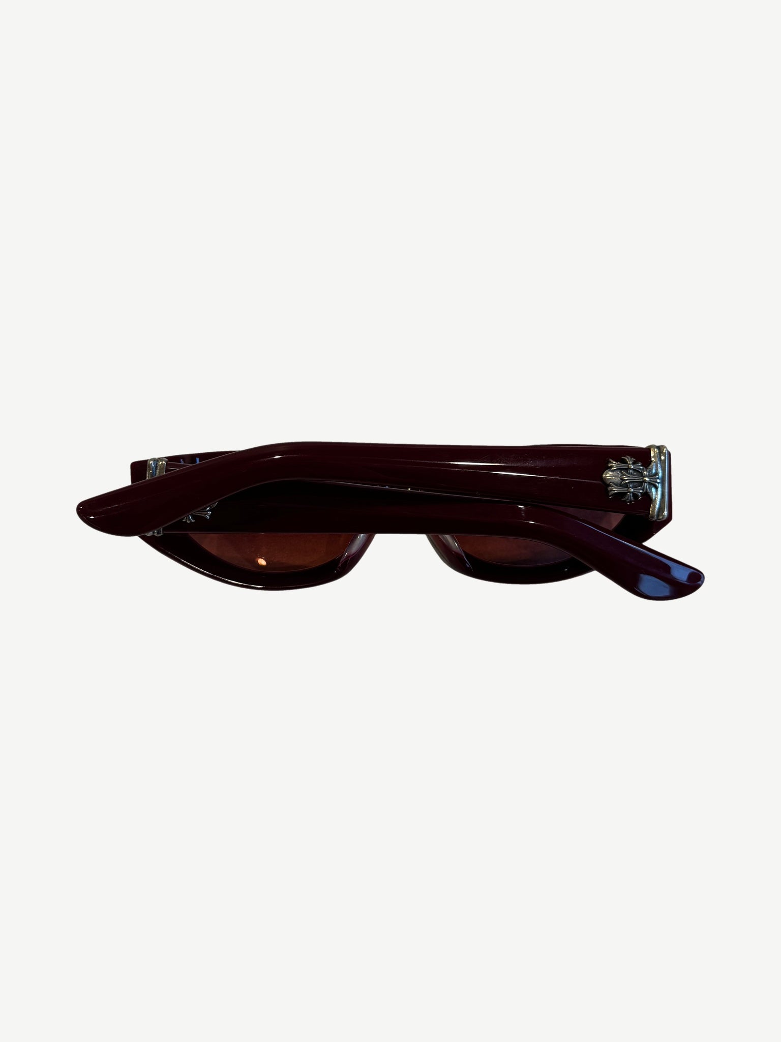 Chrome Hearts red Edenbox sunglasses side profile showing silver cross hardware at temples and burgundy arms.