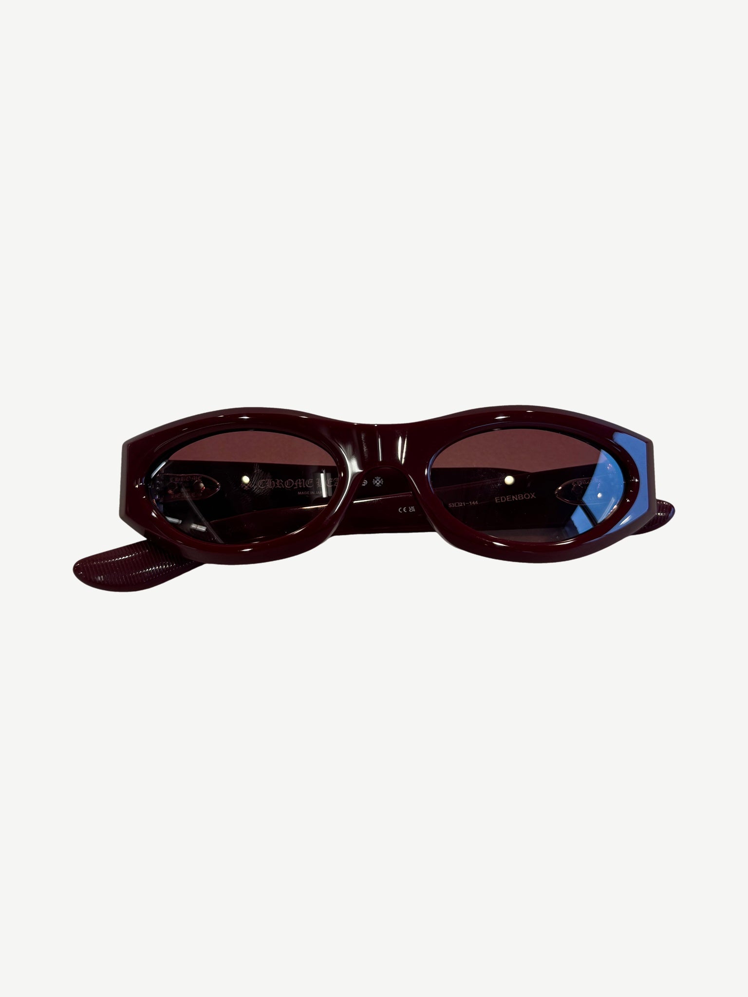Chrome Hearts Edenbox sunglasses in burgundy red acetate with oval lenses and Chrome Hearts inner branding.