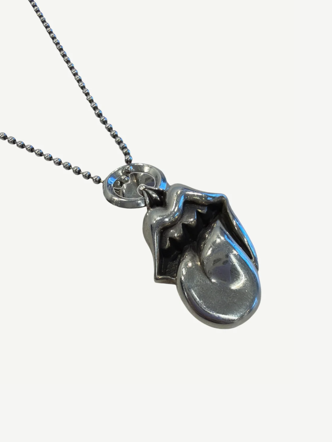 Close-up of Chrome Hearts Rolling Stones silver lips and tongue pendant showing sculpted three-dimensional detail