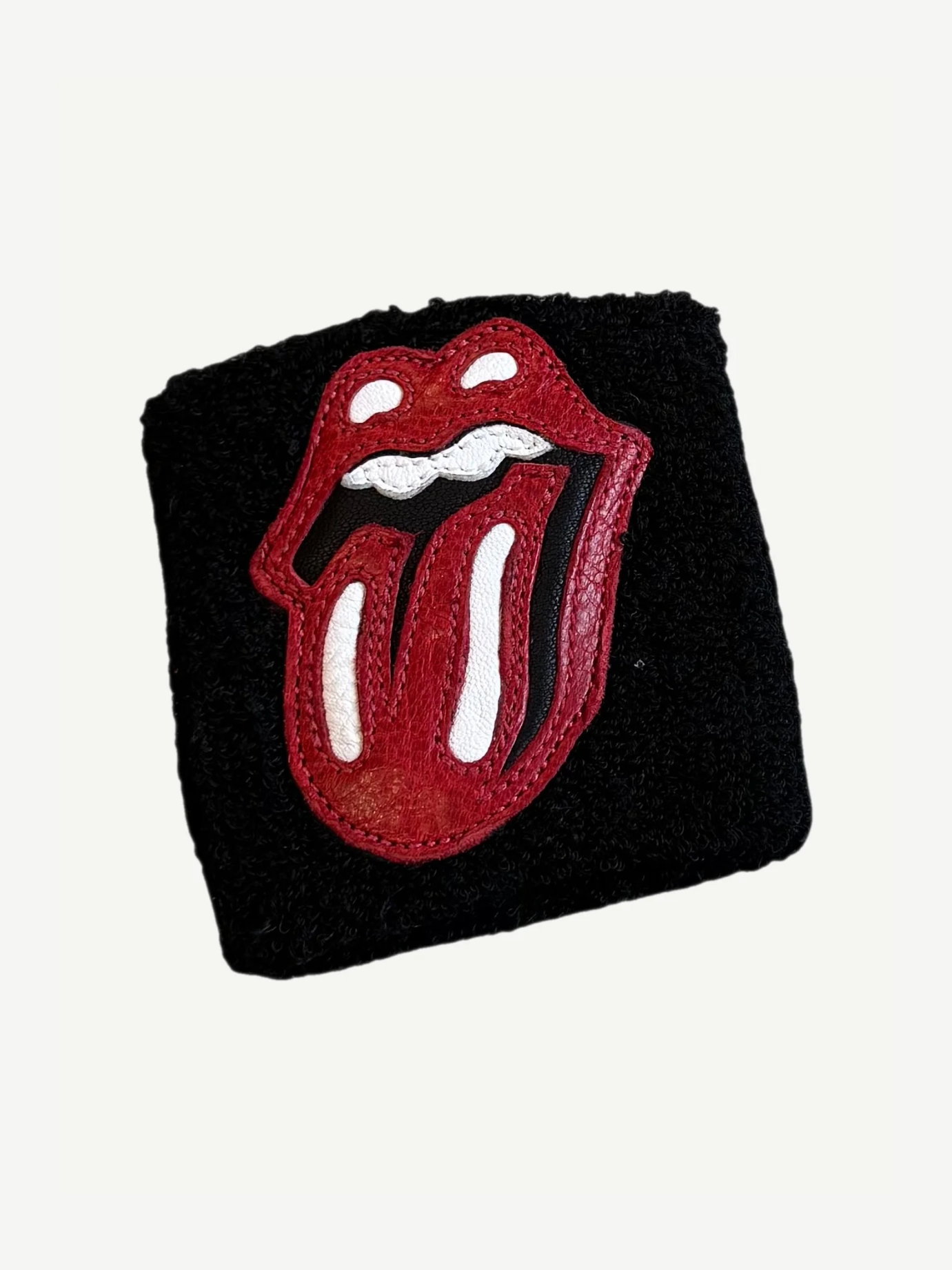 Chrome Hearts black terry wristband with applied red and white Rolling Stones tongue logo leather patch
