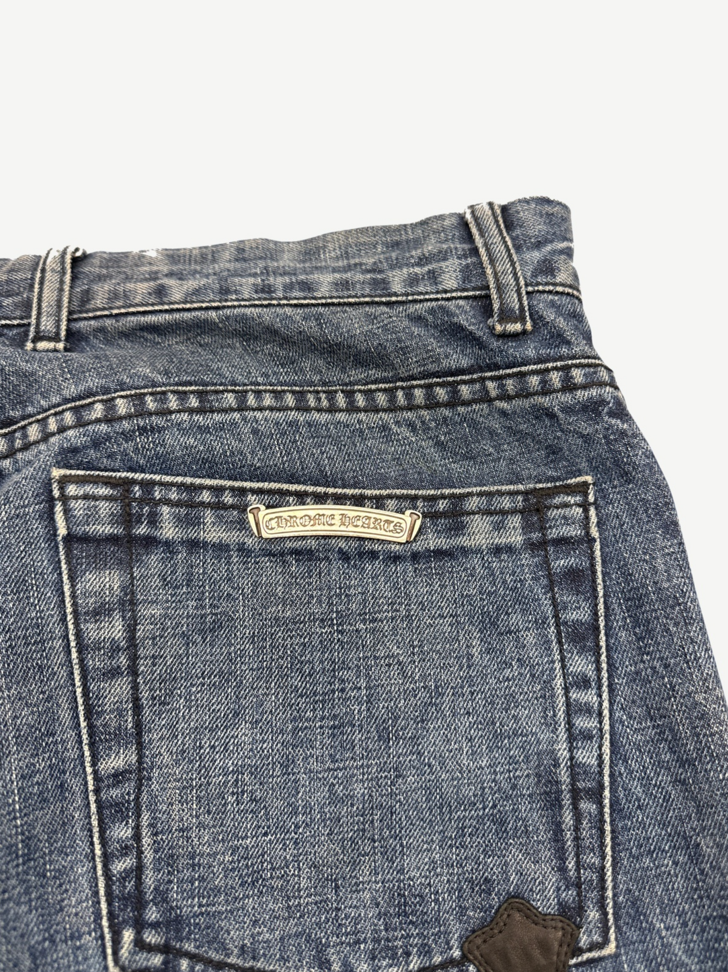 Chrome Hearts Turbo Diesel denim jeans waistband detail with branded leather logo patch close-up