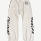 Chrome Hearts cream sweatpants front with allover tonal cross monogram and black gothic Chrome Hearts legs.