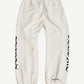 Chrome Hearts white monogram sweatpants back view with allover cross print and gothic CH leg lettering.
