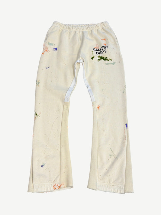 Gallery Dept cream painted flare sweatpants with multicolor paint splatters, logo and elastic waistband.